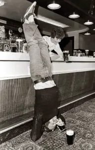Funny Prints: Drinking - A man doing a headstand in his local pub drinking his pint of beer upside down