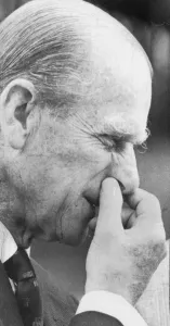 01440 Prints: The Duke of Edinburgh pinching his nose while visiting a farm - June 1963