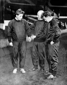 Track Suit Prints: Duncan Edwards with Matt Busby and Roger Byrne November 1957 trying on new