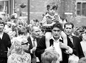 Durham Miners Gala - A child is carried on their fathers shoulders during the march