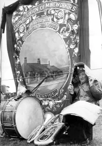 Durham Miners Gala - John Nicholson, a bandsman, shelters from the weather