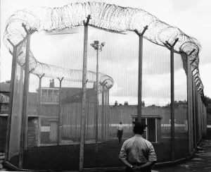 Durham Prison security wing a man in the exercise cage at Durham jail watched by a warder