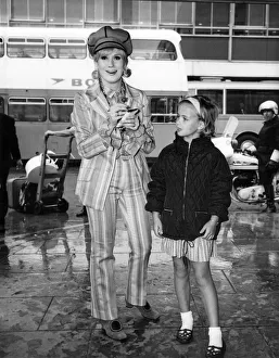 Dusty Springfield pictured at London Heathrow airport signing an autograph for a young