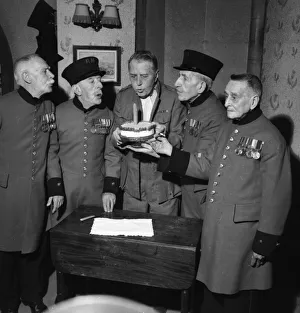 00047 Prints: A E Matthews shares hs birthday cake with Chelsea Pensioners 1954