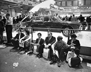 Motoring Prints: The Earls Court Motor Show. London Visitors sit on the floor in front of the Jaguar
