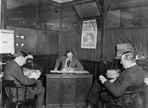 An early morning staff meeting on the Daily Mirror news desk, circa 1937