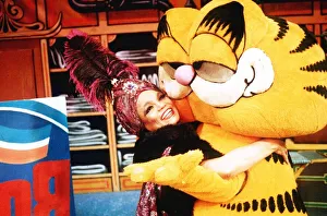Eartha Kitt Actress hugs Garfield at a Xmas Party December 1989