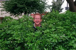 00033 Prints: Eddie Edwards May 1998 Former ski jumpersitting in a bush under a tree