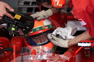 01372 Prints: Eddie Irvine gets some personal attention in the pits The 1999 British Grand