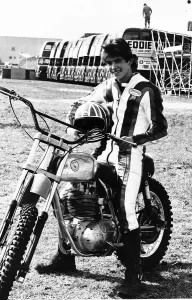 Eddie Kidd on his motorcycle infront of a line of buses he is about to attempt to jump