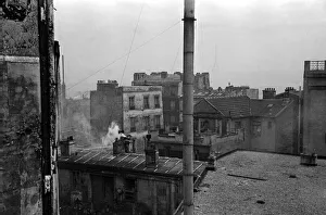 Paris Prints: The Eiffel tower seen in the distance from the rooftops of the Artust quarter of Paris