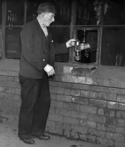 Eighty years old Joseph Brogan collecting his lamp prior to working his shift at the pit