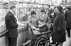 Wheelchair Prints: Elderly and disabled shoppers looking for bargain Christmas presents at Woolworths store
