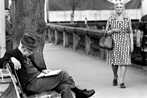 An elderly gent reading his newspaper on a park bench in Luxembourg City