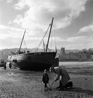 Fisherman Prints: An elderly man at the harbour in the village of St Ives in Cornwall with a young boy