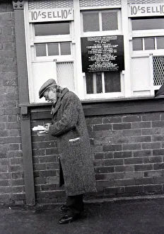 An elderly man holding his receipts after placing a bet on the tote before a race