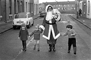 An elderly woman dressed as Santa Claus on her way to an engagement accompanied by
