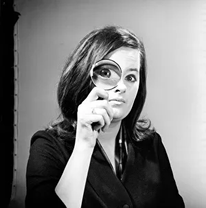 00092 Prints: Elementary my dear Watson. Woman holding magnifying glass. Model: Jennie Cropper