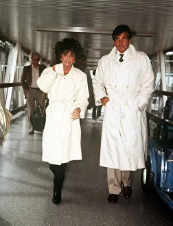 Trench Coat Prints: Elizabeth Taylor actress August 1986 at Heathrow Airport with George Hamilton