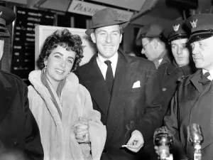 Suits And Jackets Prints: Elizabeth Taylor on arrival at the London Airport with Michael Wilding