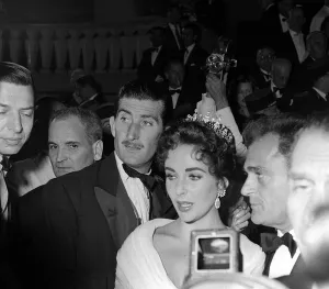 Elizabeth Taylor and husband Mike Todd (R) leaving the Opening Night at Cannes Film