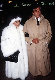 Elizabeth Taylor Jan 1987 wearing white fur coat at Heathrow Airport with George