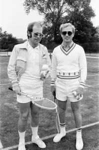 Elton John with Larry King (husband of Billie-Jean King) at Wimbledon playing tennis
