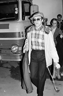 01320 Prints: Elton John leaving the Empire Pool Wembley by the back door after he announced his