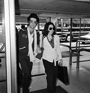 Elton John leaving Heathrow airport hand in hand with Connie Papras