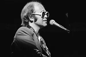 Elton John performing on stage, during the Elton John and Ray Cooper concert tours