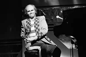 Elton John performing on stage, during the Elton John and Ray Cooper concert tours
