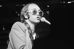 Elton John performing on stage, during the Elton John and Ray Cooper concert tours