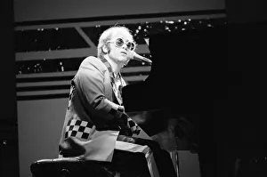 Elton John performing on stage, during the Elton John and Ray Cooper concert tours