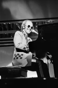 Elton John performing on stage, during the Elton John and Ray Cooper concert tours