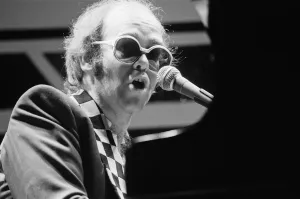 Elton John performing on stage, during the Elton John and Ray Cooper concert tours