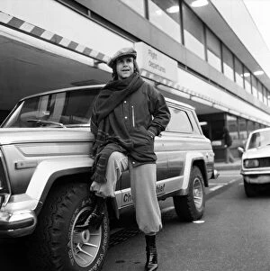 01069 Collection: Elton John pictured next to an American Jeep at London Airport. February 1979