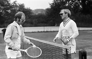 Elton John plays tennis against Larry King on an outer court at Wimbledon. 25th June 1974