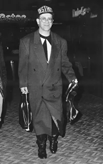 Knighthood Prints: Elton John pop singer at Heathrow Airport on his way to see friends in Canada