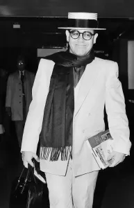 Elton John pop star strolls through the airport on his way to a Californian holiday