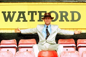 Knighthood Prints: Elton John on rejoining Watford football club as director sitting in front of sign white