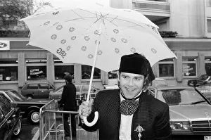 Musicians Prints: Elton John standing in the rain. He is in Montreux to perform at the Montreux Pop