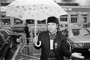 01073 Prints: Elton John standing in the rain. He is in Montreux to perform at the Montreux Pop