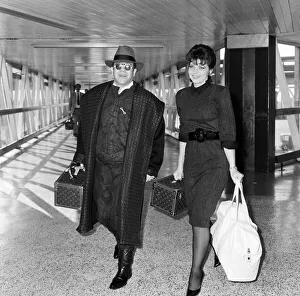 Pianist Prints: Elton John with his wife Renate arriving from Los Angeles at London Airport