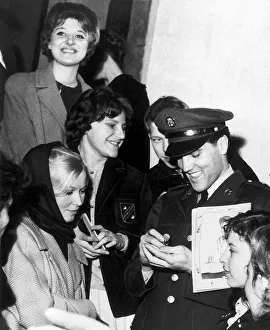 Elvis Presley signing autographs while in Germany on service with the U. S. army