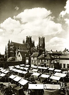 Skyline Prints: Ely Cathedral Cambridgeshire over looking the town square on a market day