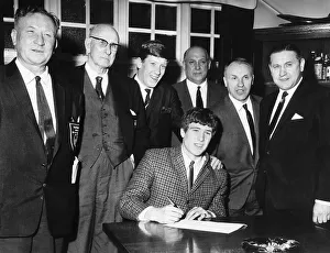 Emlyn Hughes signs for Liverpool FC February 1967 watched by Bill Shankly second