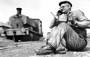 An engineer taking a break from working on this old steam locomotive on 21st August 1972