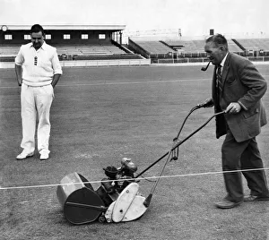 00059 Prints: England batsman Colin Cowdrey watches groundsman Bert Flack add the finishing touches to