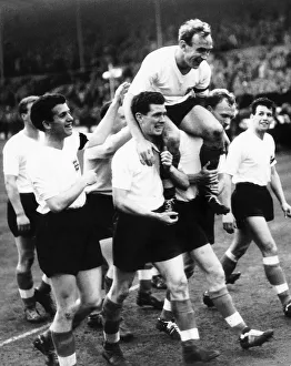 00222 Prints: England captain Billy Wright is carried shoulder high from pitch followingt victory over