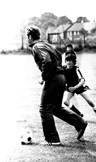 Former England footballer Bobby Moore coaches children at the Coral sponsored Bobby Moore